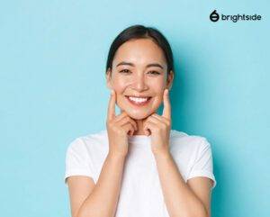 Woman smiling brightly with blue background