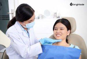 Dentist examining patient's oral health in clinic.