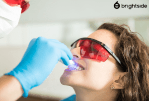 Woman receiving teeth whitening treatment