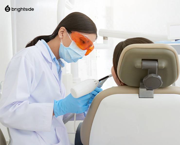 Image of a dentist administering teeth whitening treatment