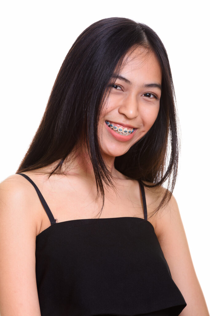 close up of young happy asian teenage girl smiling