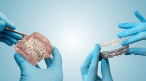veneers pain blog pics (4)Gloved hands holding braces on left and aligners on right