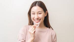 woman holding veneers in singapore
