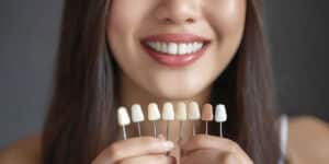 Woman holding veneers.